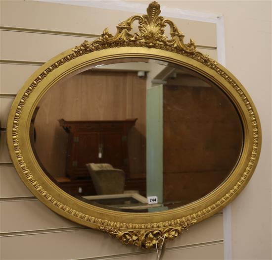 A gilt painted oval wall mirror W.88cm